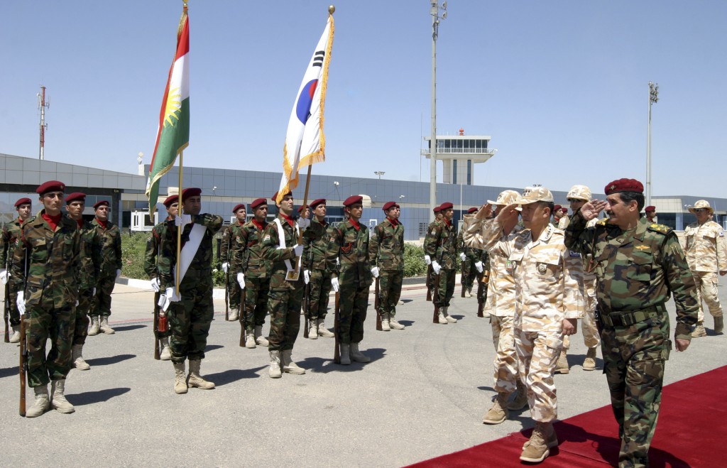 Iraq's Minister for Peshmerga Affairs in the Kurdistan region Omar and South Korea's Chairman of the Joint Chiefs of Staff General Kim salute in Arbil